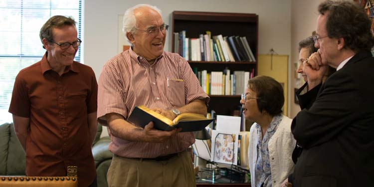 Michael Chilton pages through one of the rare botanical books he donated to the NUNM Library.