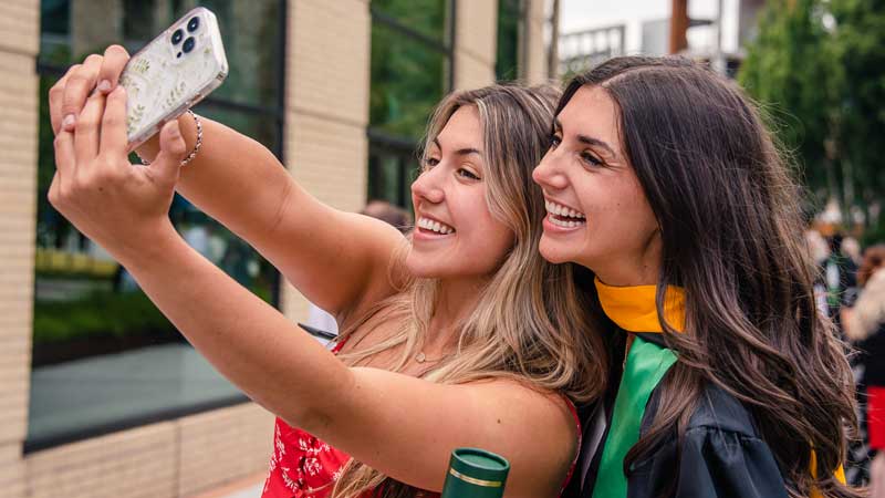 Two graduates taking a selfie