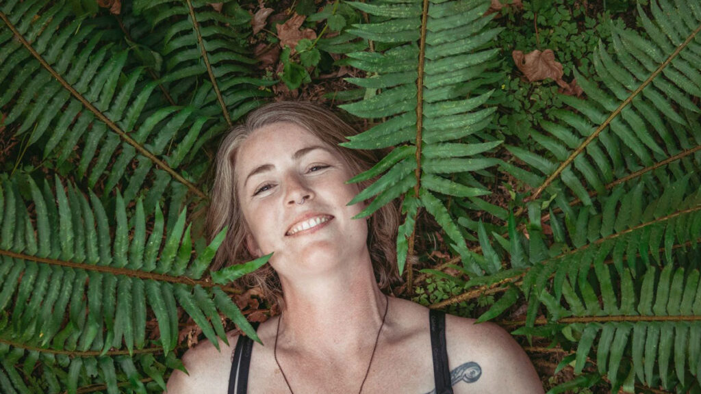 Jamie Manzel lying with her head in ferns