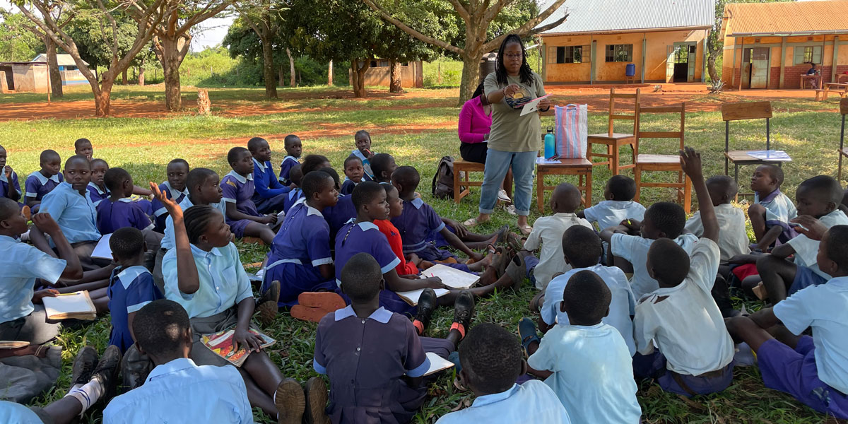 Student talking to children in Kenya