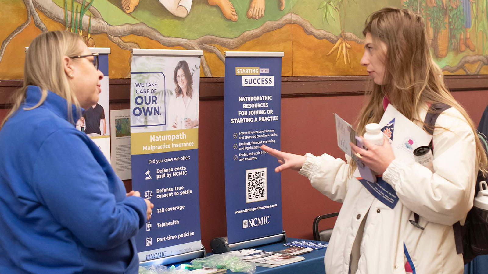 Student speaks with insurance partner at Partner Fair booth