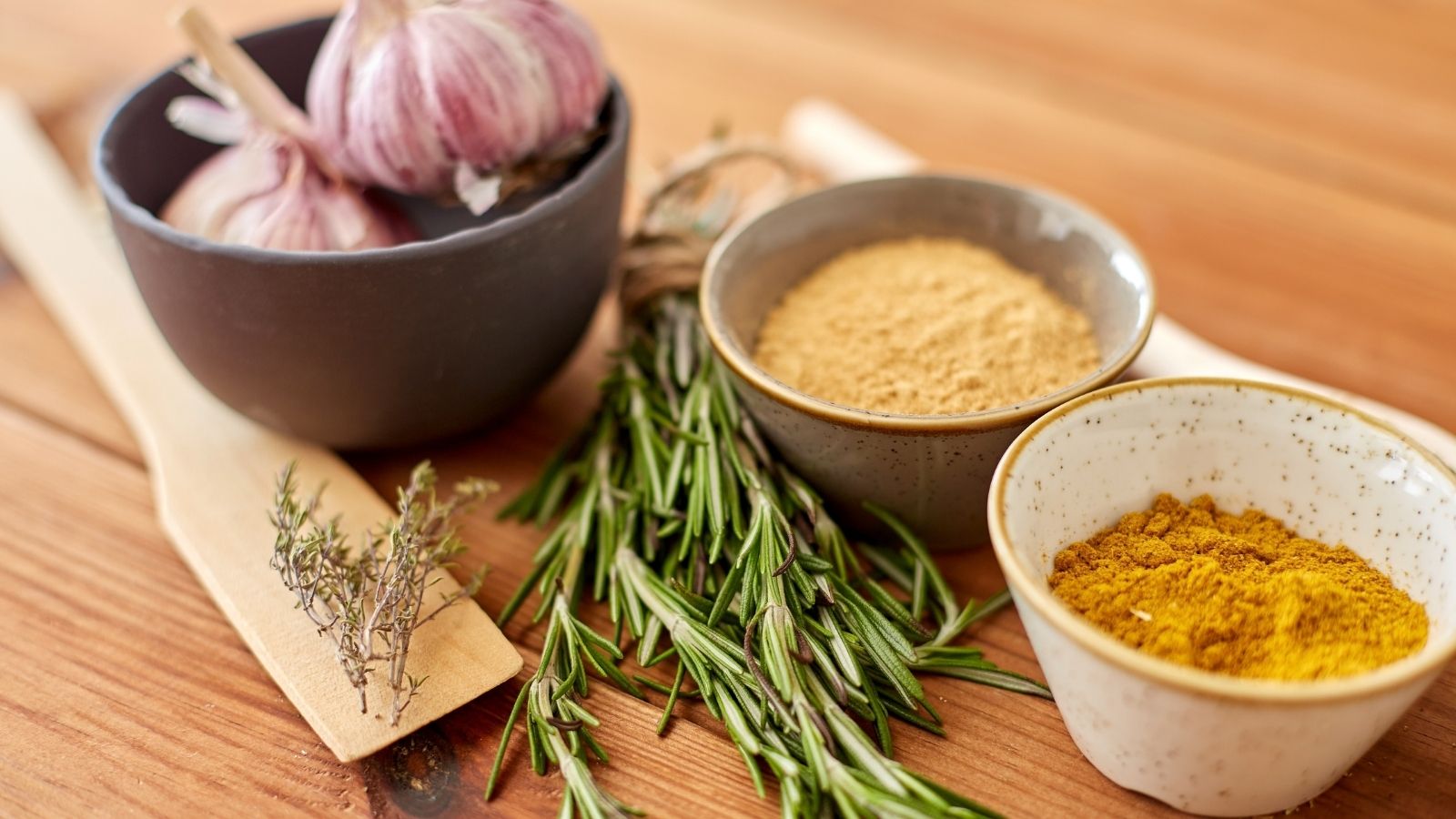 Garlic, rosemary, turmeric on table