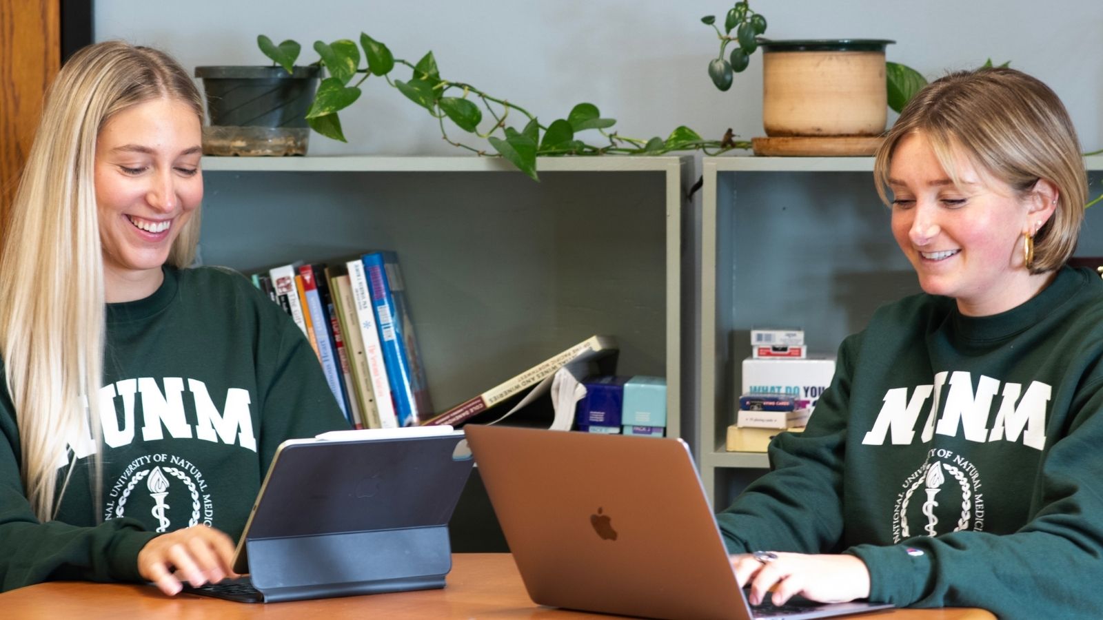 NUNM students sit at desk with laptops