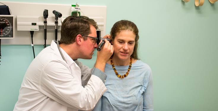 Doctor examines patients ears
