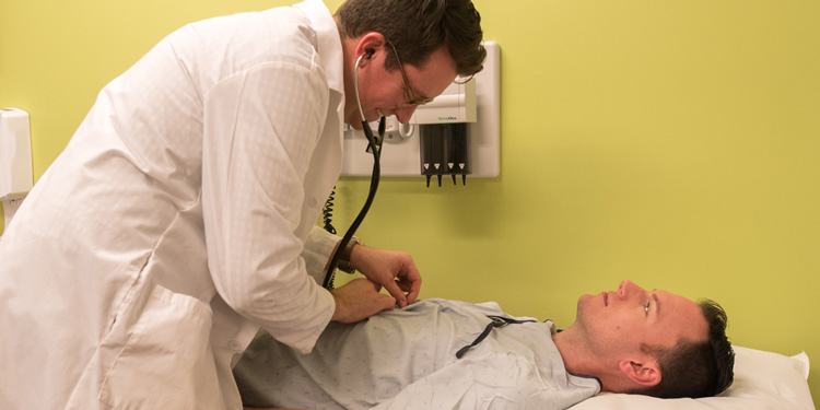 Doctor examining patient stomach