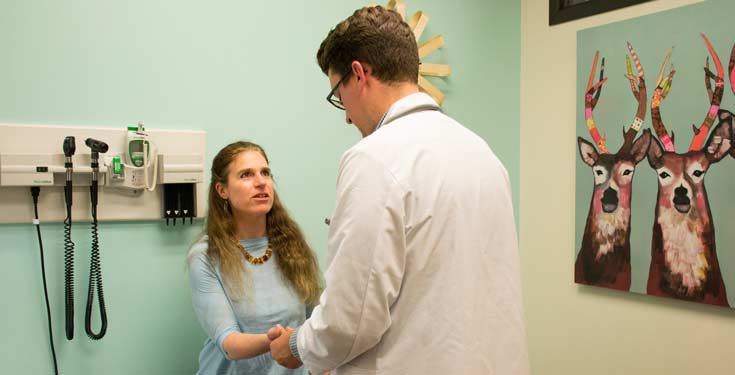 doctor checking woman's wrist