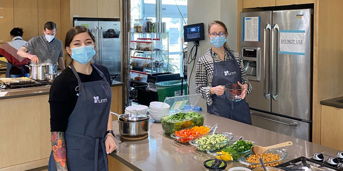 Jenna Moreno (left) with fellow Master of Nutrition students in the Teaching Kitchen at the National University of Natural Medicine (NUNM).