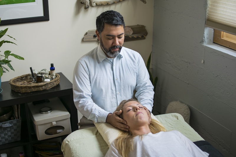A massage therapy student applies what they've learned in NUNM's massage therapy school.