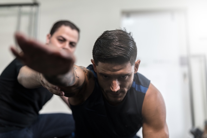 An Exercise Science graduate helps a client improve their wellness through personalized fitness.