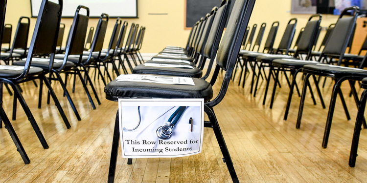 Chairs with a sign saying this row reserved for incoming students