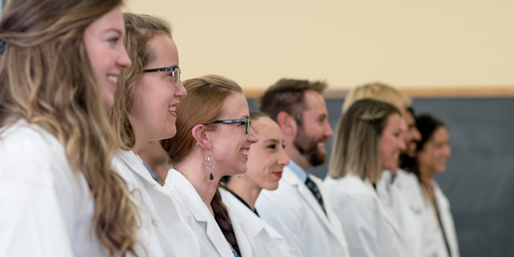 Smiling people in white coats