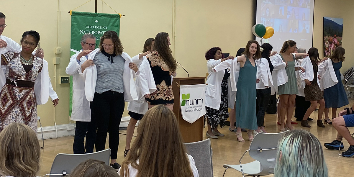 45 new students representing the Class of 2026 Doctor of Naturopathic Medicine (ND) degree program donned their white coats for the first time at an in-person and virtual ceremony held Sept. 8, 2022. on the NUNM campus