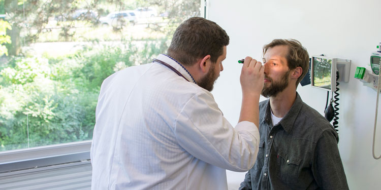 a doctor examining a patient inside a clinic