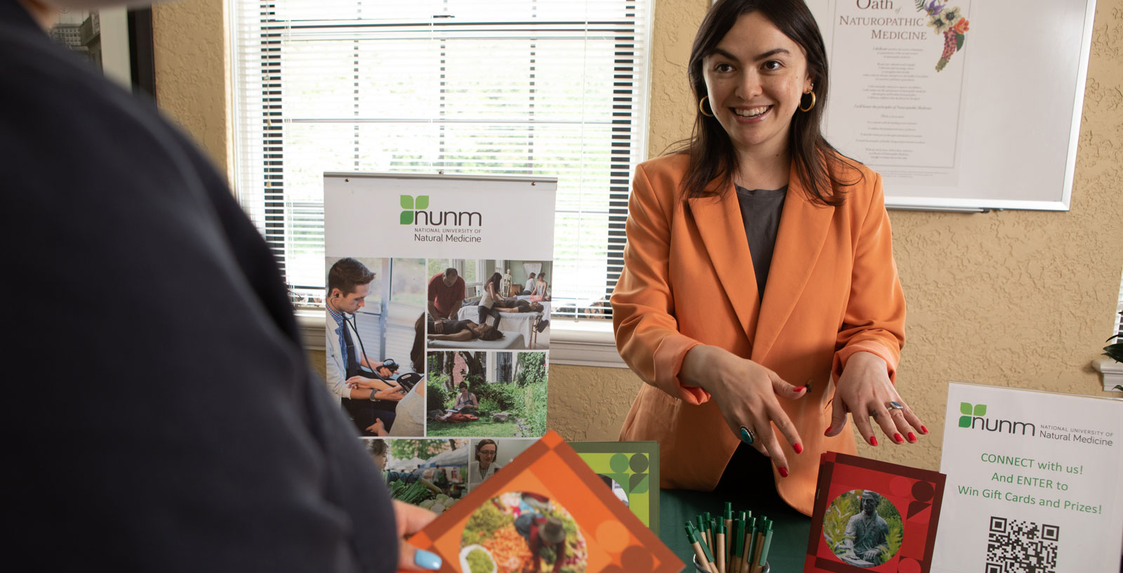 Woman talking and gesturing at a brochure