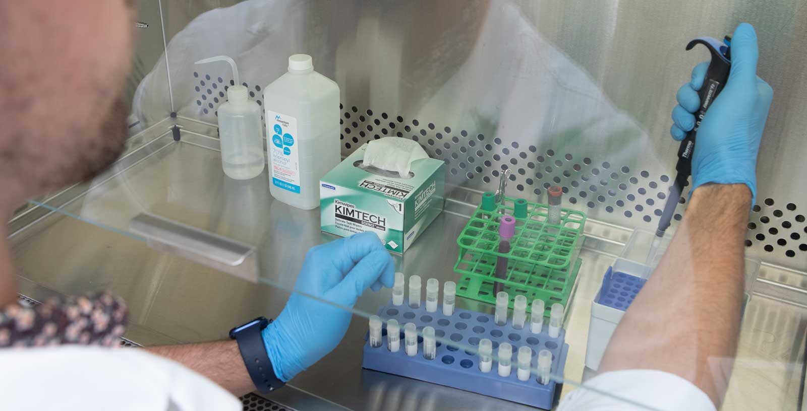 Researcher in lab using tools